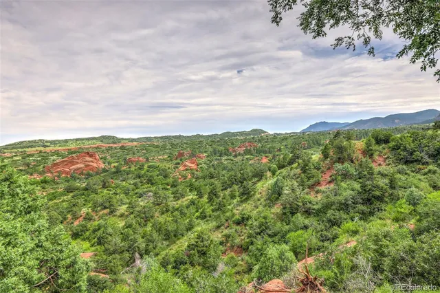 an aerial view of residential house with green space