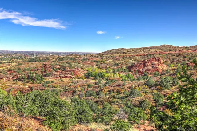 an aerial view of a house with a mountain