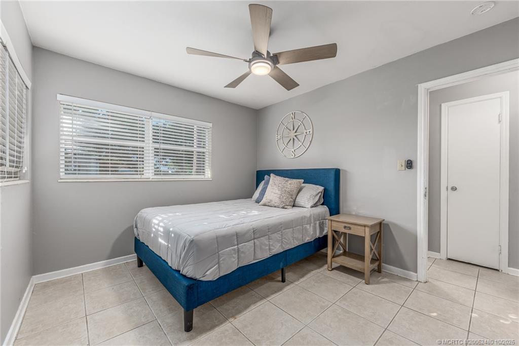 3156 Southeast Mimosa Street Stuart, FL 34997 - Photo 21 of 38 a bedroom with a bed and a table