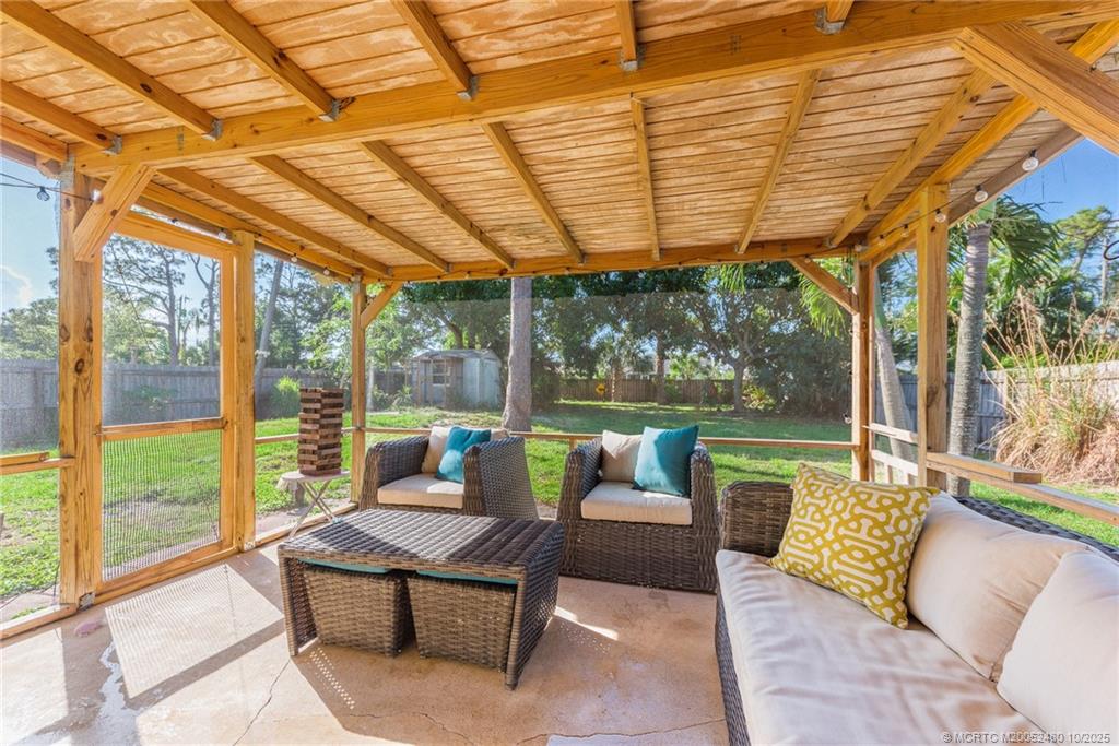 3156 Southeast Mimosa Street Stuart, FL 34997 - Photo 25 of 38 a patio with patio outdoor seating and yard
