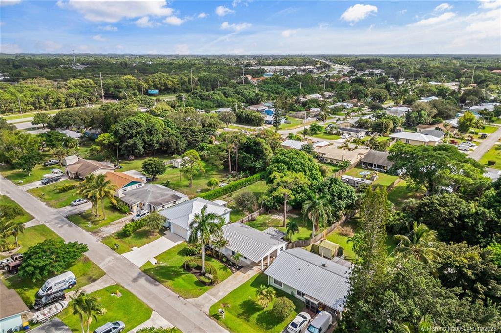 3156 Southeast Mimosa Street Stuart, FL 34997 - Photo 7 of 38 an aerial view of residential houses with outdoor space and trees