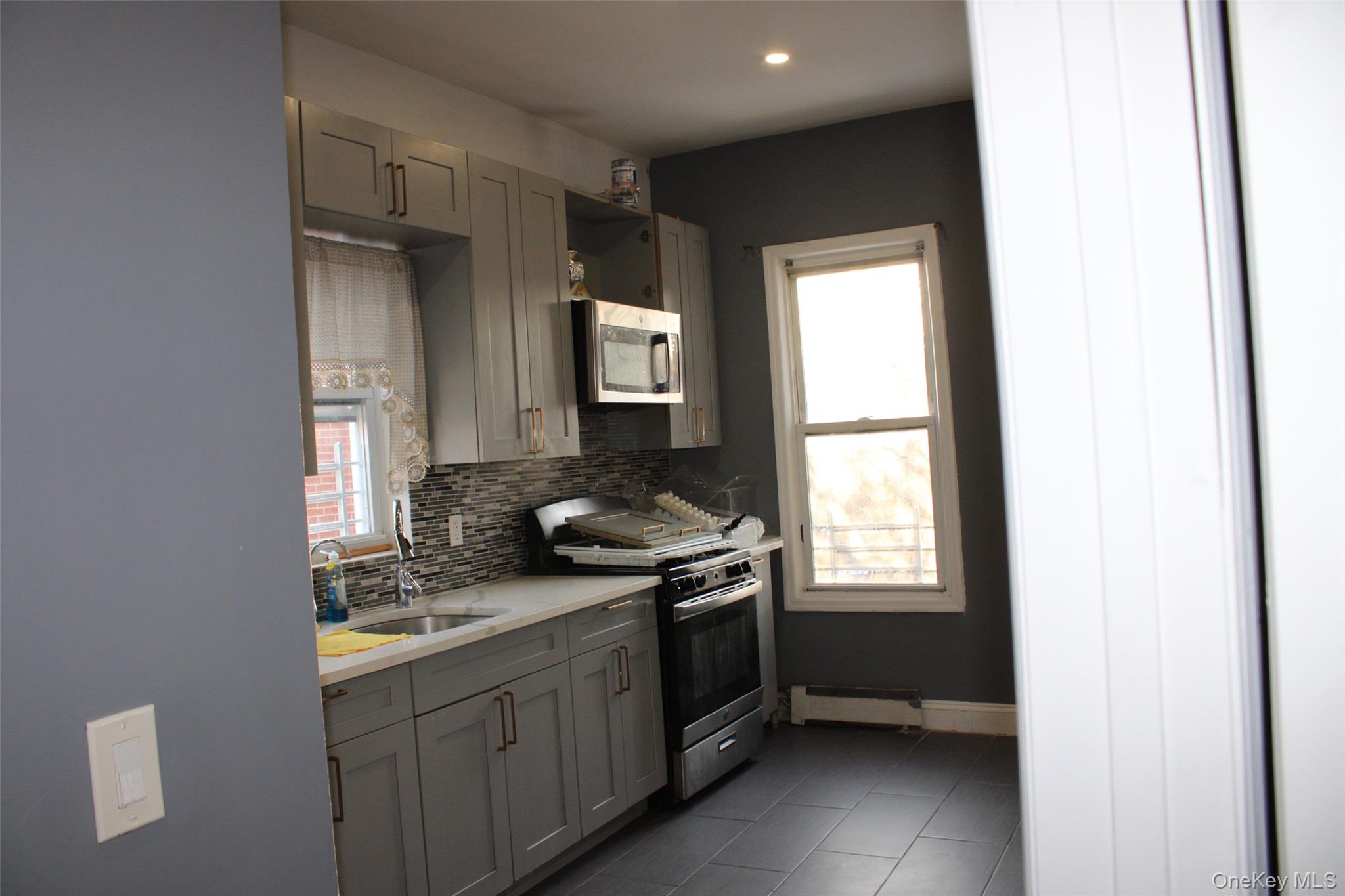 1837 Victor Street Bronx, NY 10462 - Photo 2 of 10 a kitchen with a sink stove and cabinets