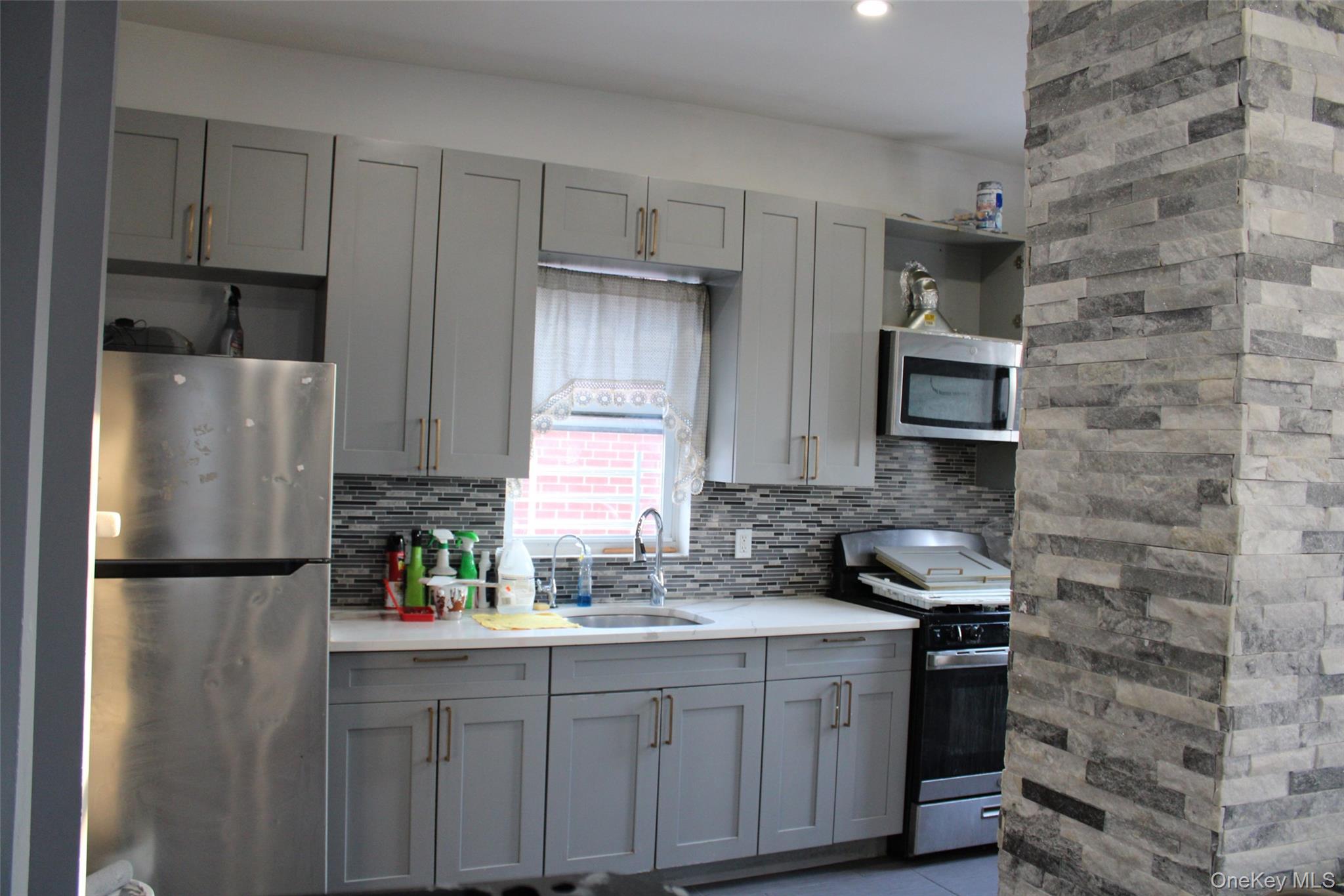 1837 Victor Street Bronx, NY 10462 - Photo 6 of 10 a kitchen with stainless steel appliances a refrigerator sink and cabinets