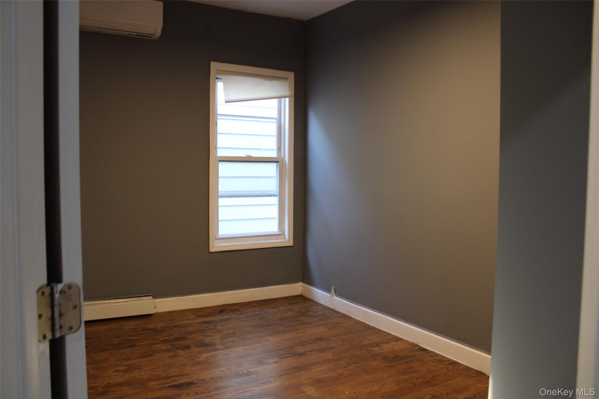 1837 Victor Street Bronx, NY 10462 - Photo 10 of 10 an empty room with wooden floor and windows