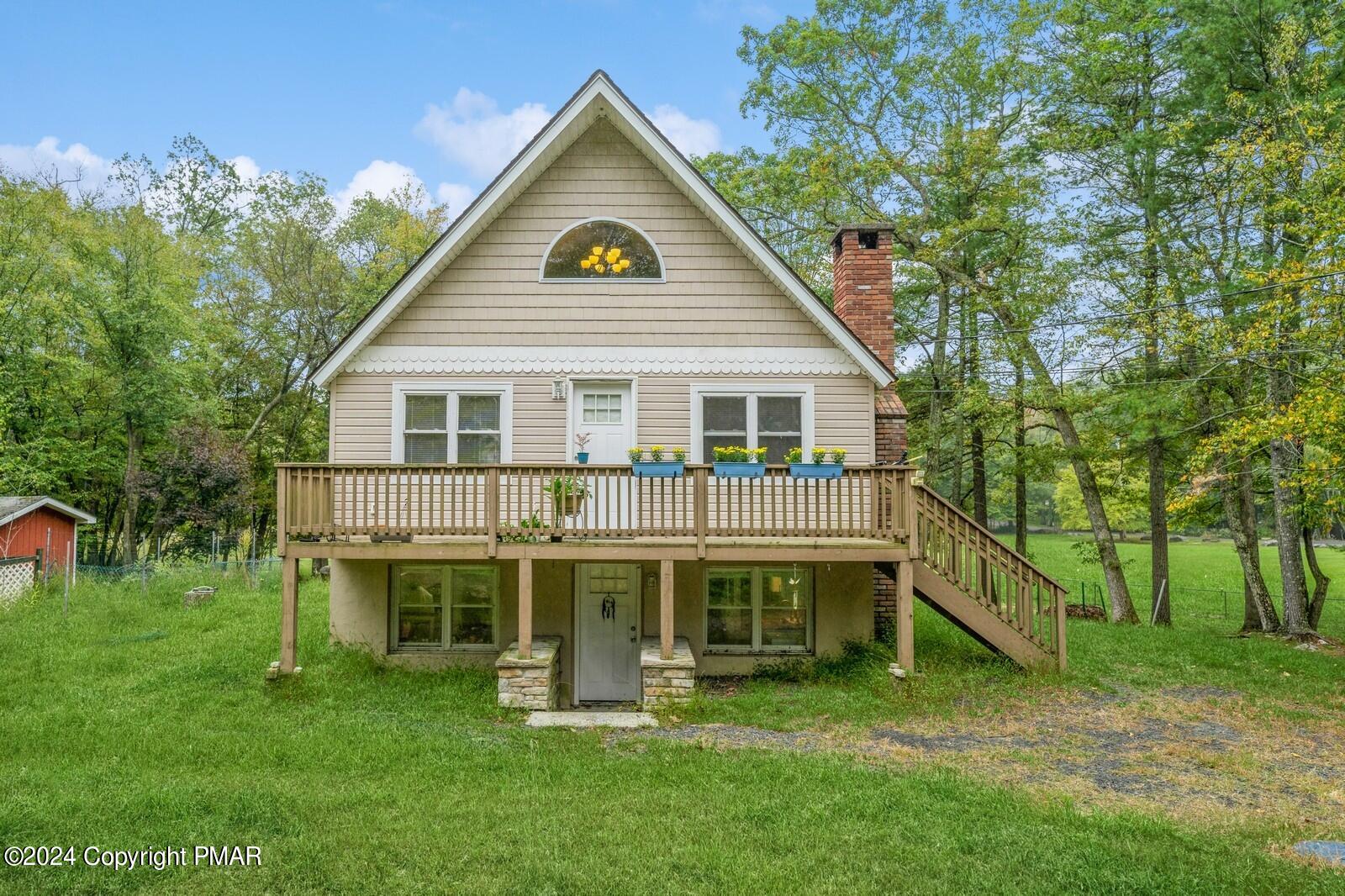 104 Swan Drive Dingmans Ferry, PA 18328 - Photo 1 of 36 a view of a house with a yard