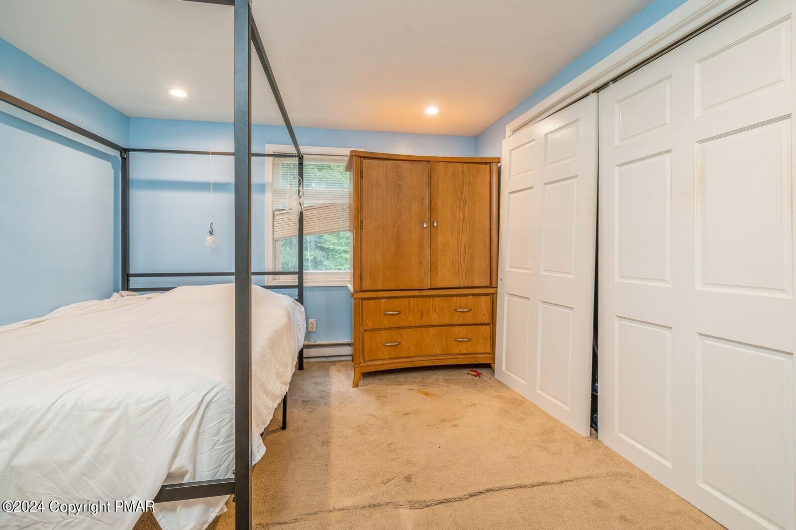 104 Swan Drive Dingmans Ferry, PA 18328 - Photo 19 of 36 a view of a bedroom with wooden floor and cabinet