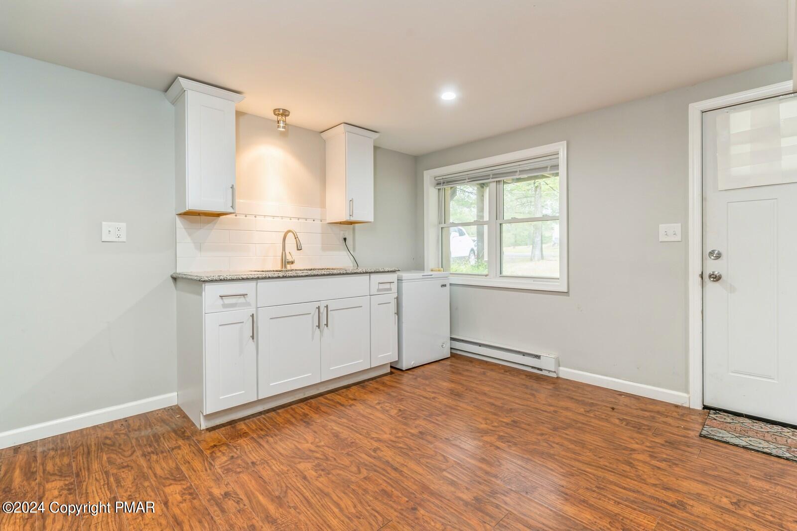 104 Swan Drive Dingmans Ferry, PA 18328 - Photo 28 of 36 a view of a kitchen with wooden floor and window