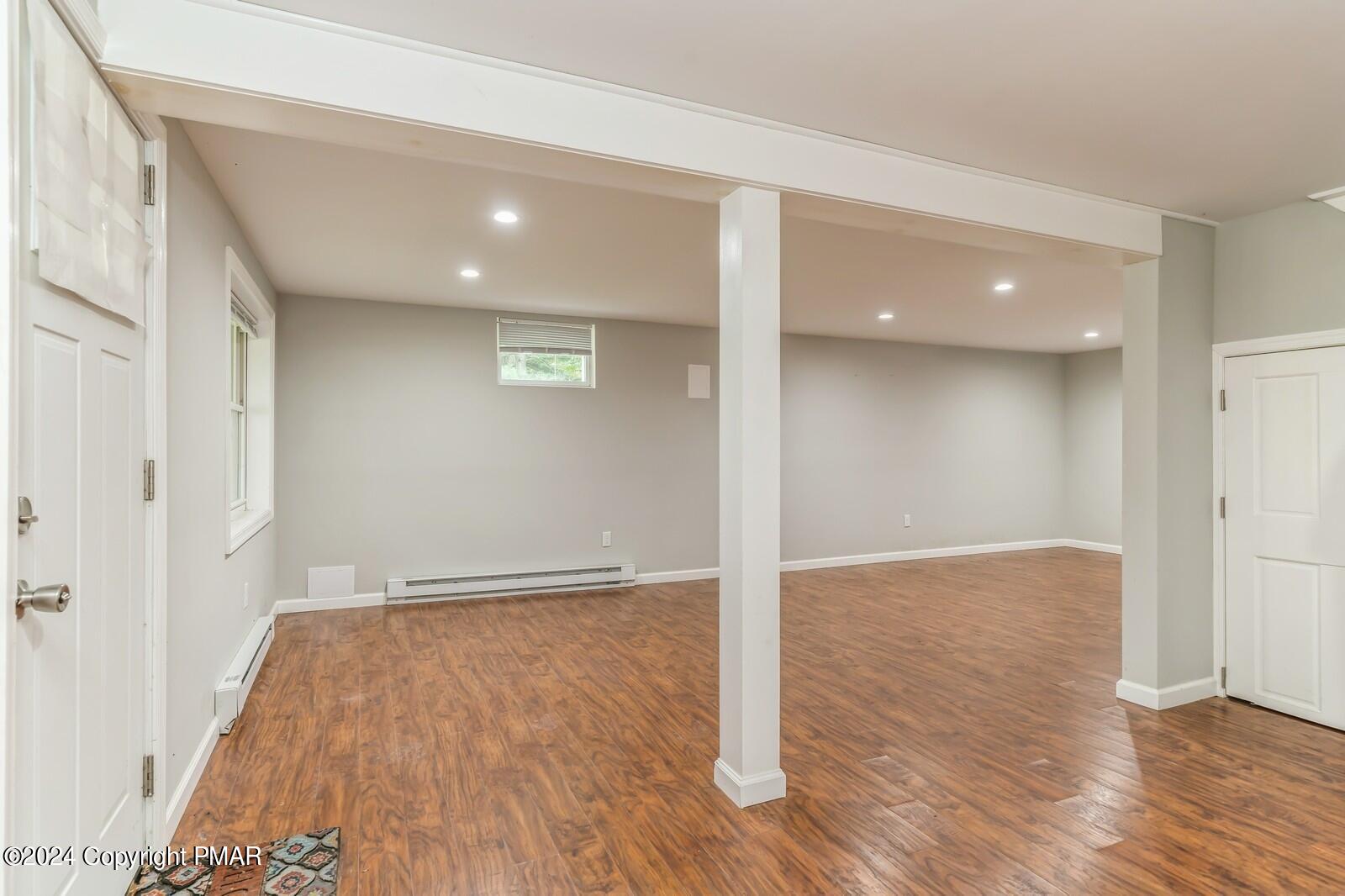 104 Swan Drive Dingmans Ferry, PA 18328 - Photo 30 of 36 wooden floor in an empty room with a window