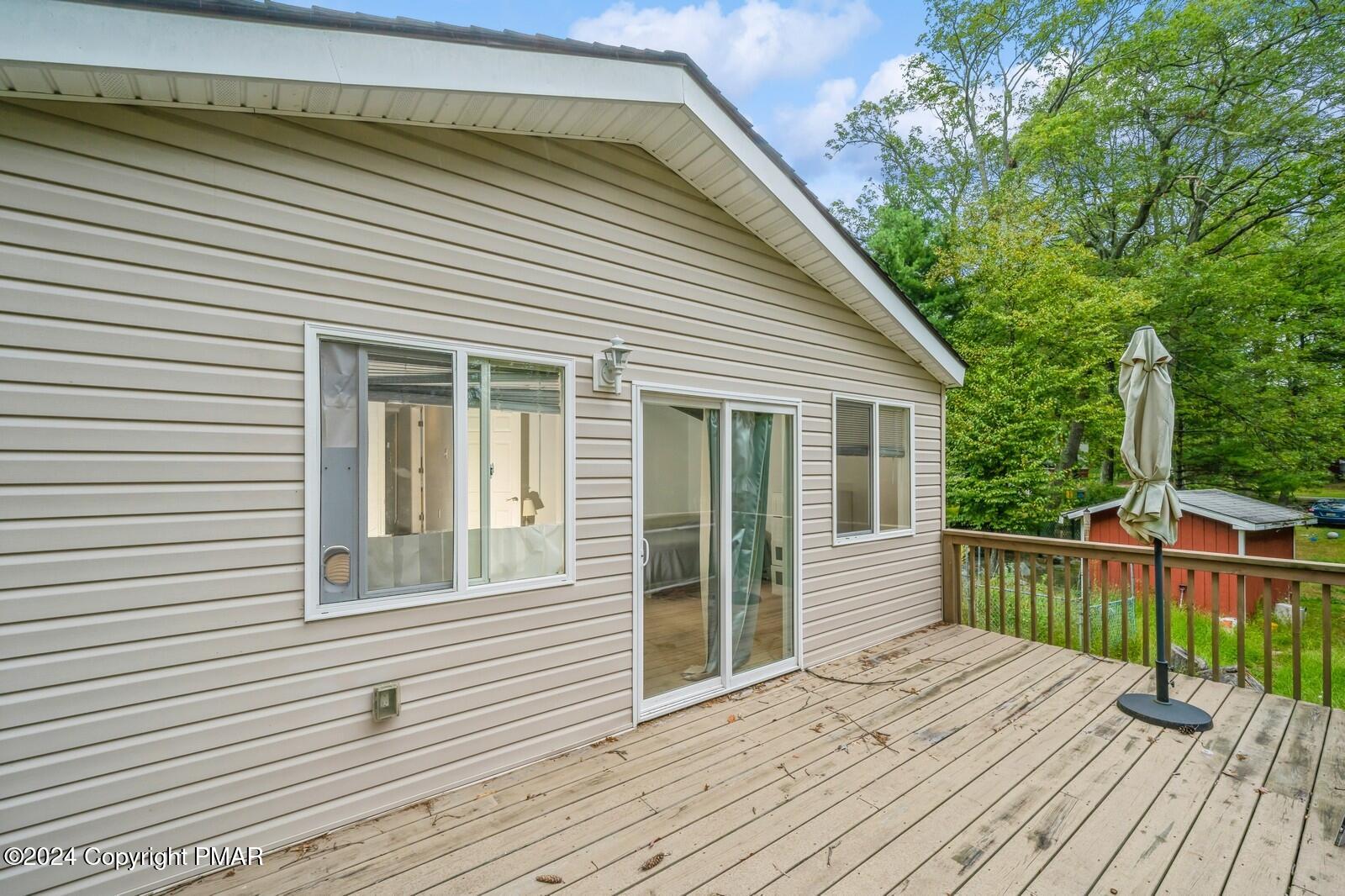 104 Swan Drive Dingmans Ferry, PA 18328 - Photo 33 of 36 a view of a house with a deck