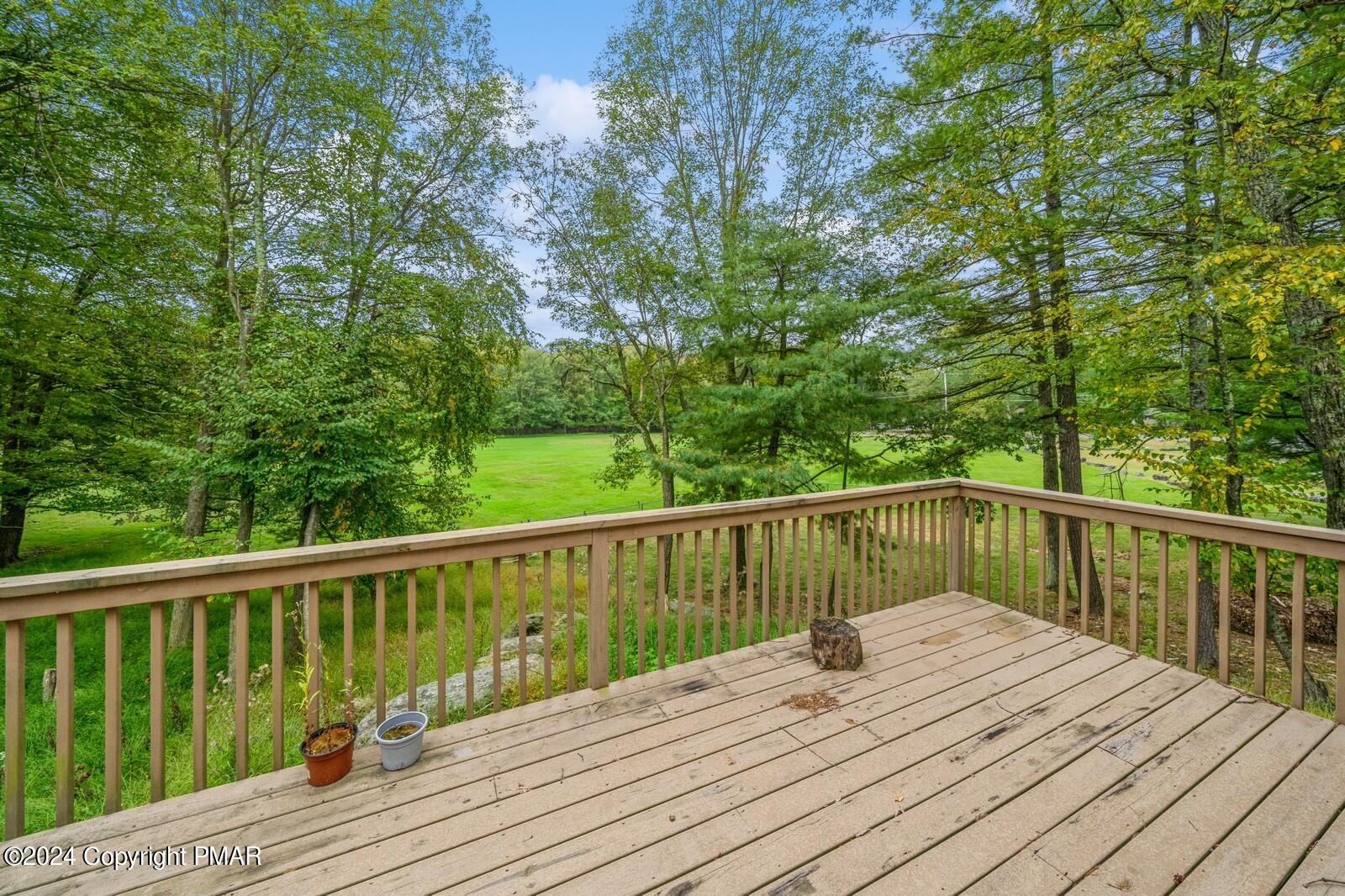 104 Swan Drive Dingmans Ferry, PA 18328 - Photo 34 of 36 a balcony with wooden floor and fence