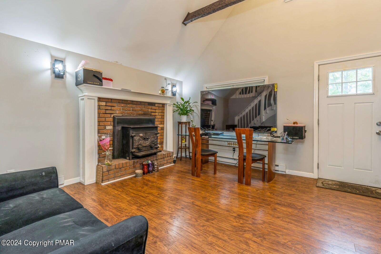 104 Swan Drive Dingmans Ferry, PA 18328 - Photo 5 of 36 a living room with furniture and a fireplace