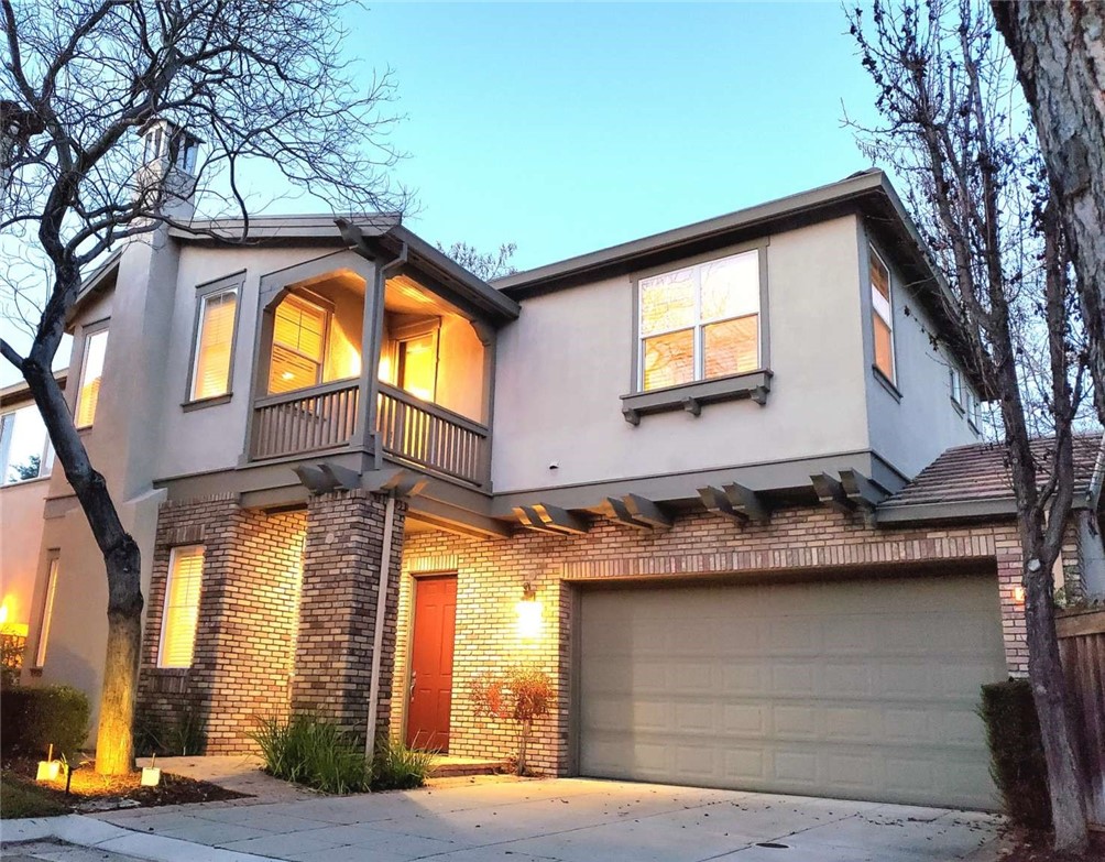 a view of a house with a door and a tree
