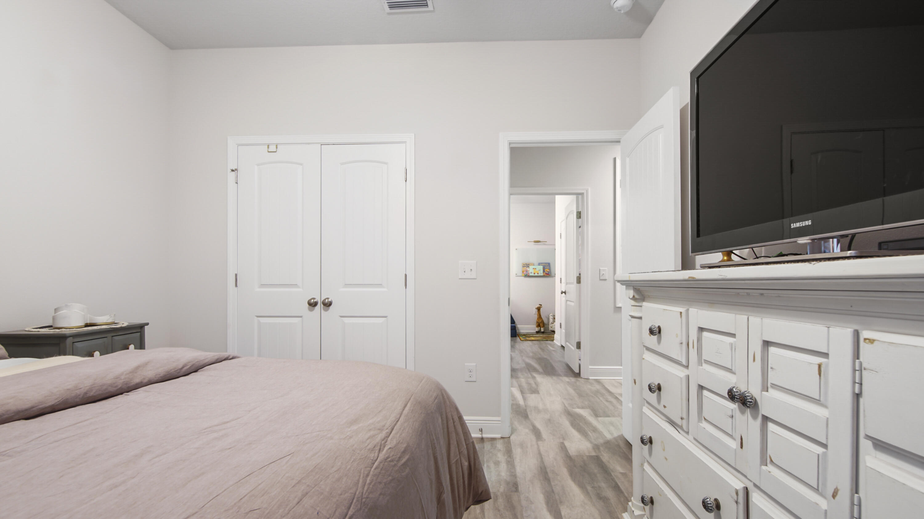 38 Norwich Road Freeport, FL 32439 - Photo 22 of 42 a bedroom with a bed and a flat tv screen on dresser