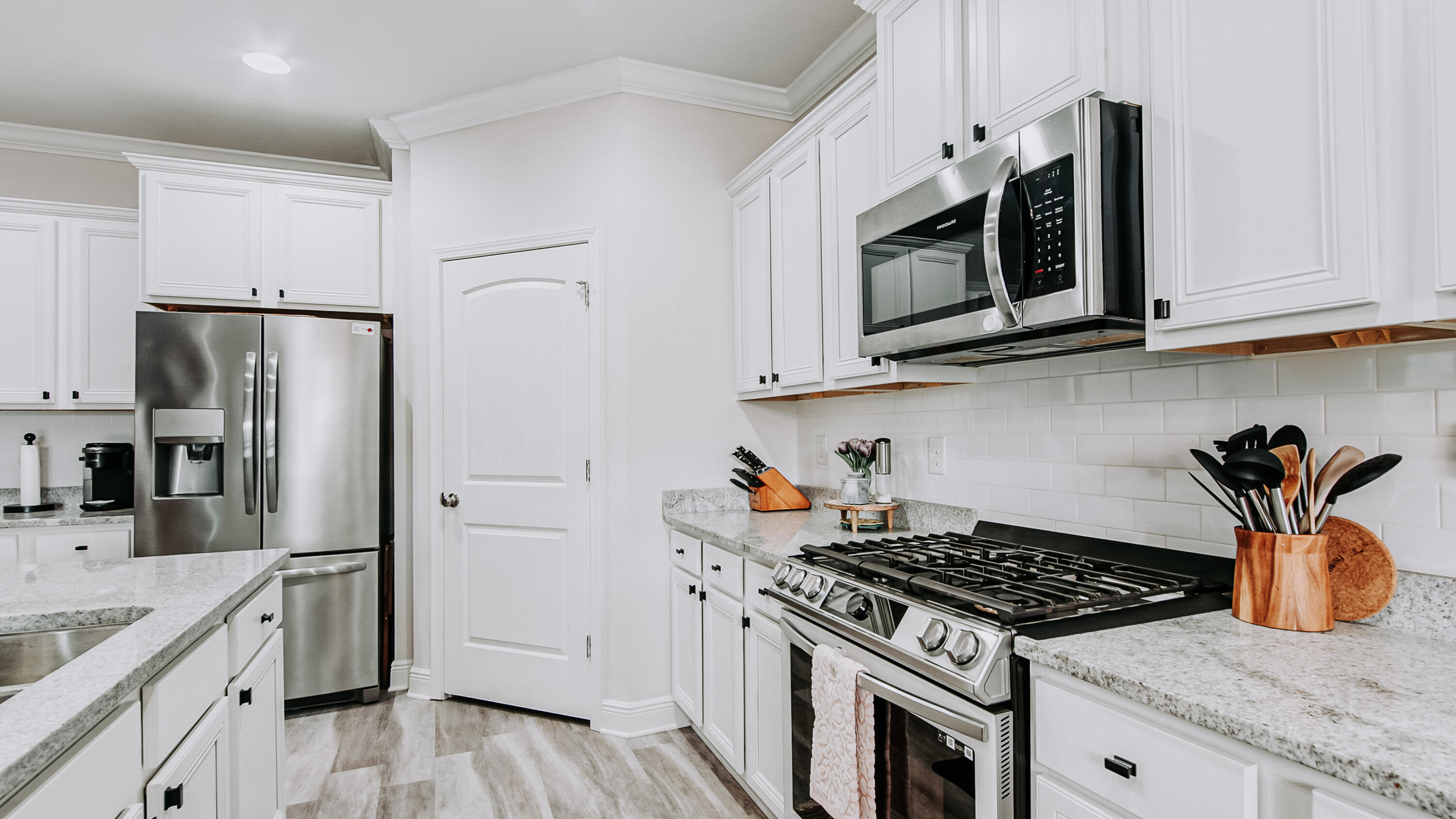 38 Norwich Road Freeport, FL 32439 - Photo 4 of 42 a kitchen with stainless steel appliances granite countertop a stove a sink dishwasher a refrigerator and microwave with wooden floor