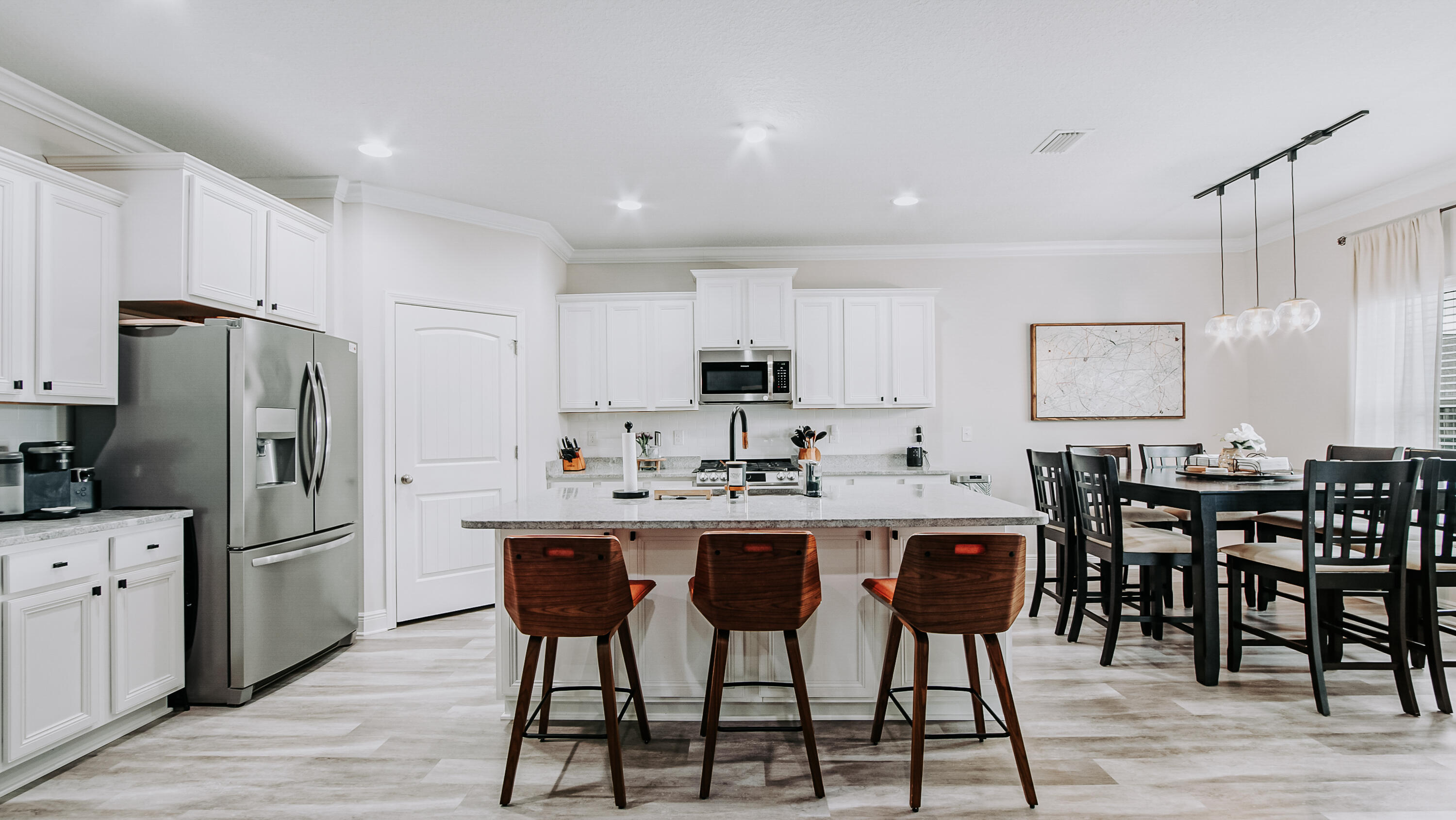 38 Norwich Road Freeport, FL 32439 - Photo 5 of 42 a kitchen with stainless steel appliances a dining table chairs refrigerator and cabinets