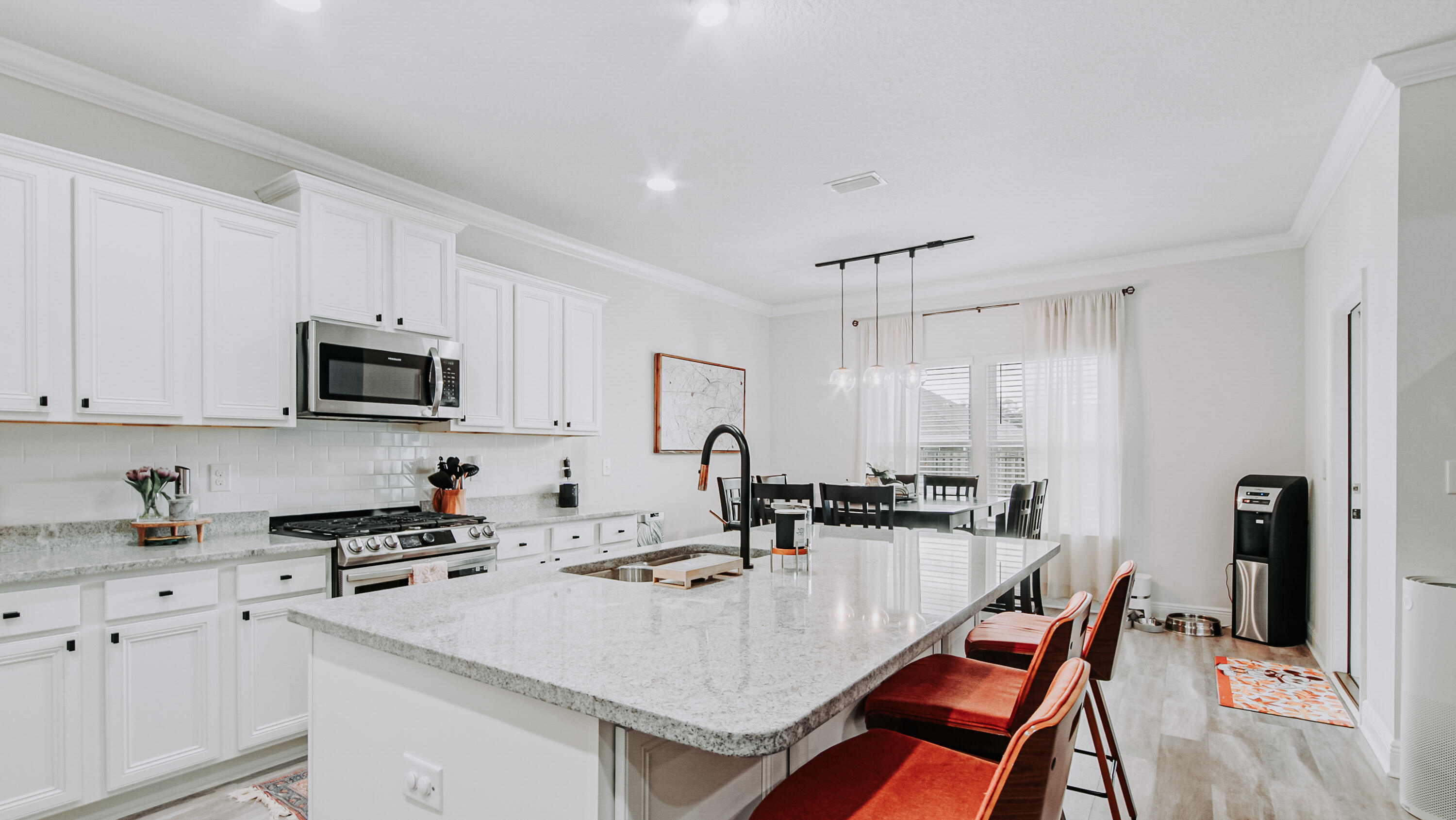 38 Norwich Road Freeport, FL 32439 - Photo 6 of 42 a kitchen with stainless steel appliances a sink a stove a refrigerator cabinets and a dining table