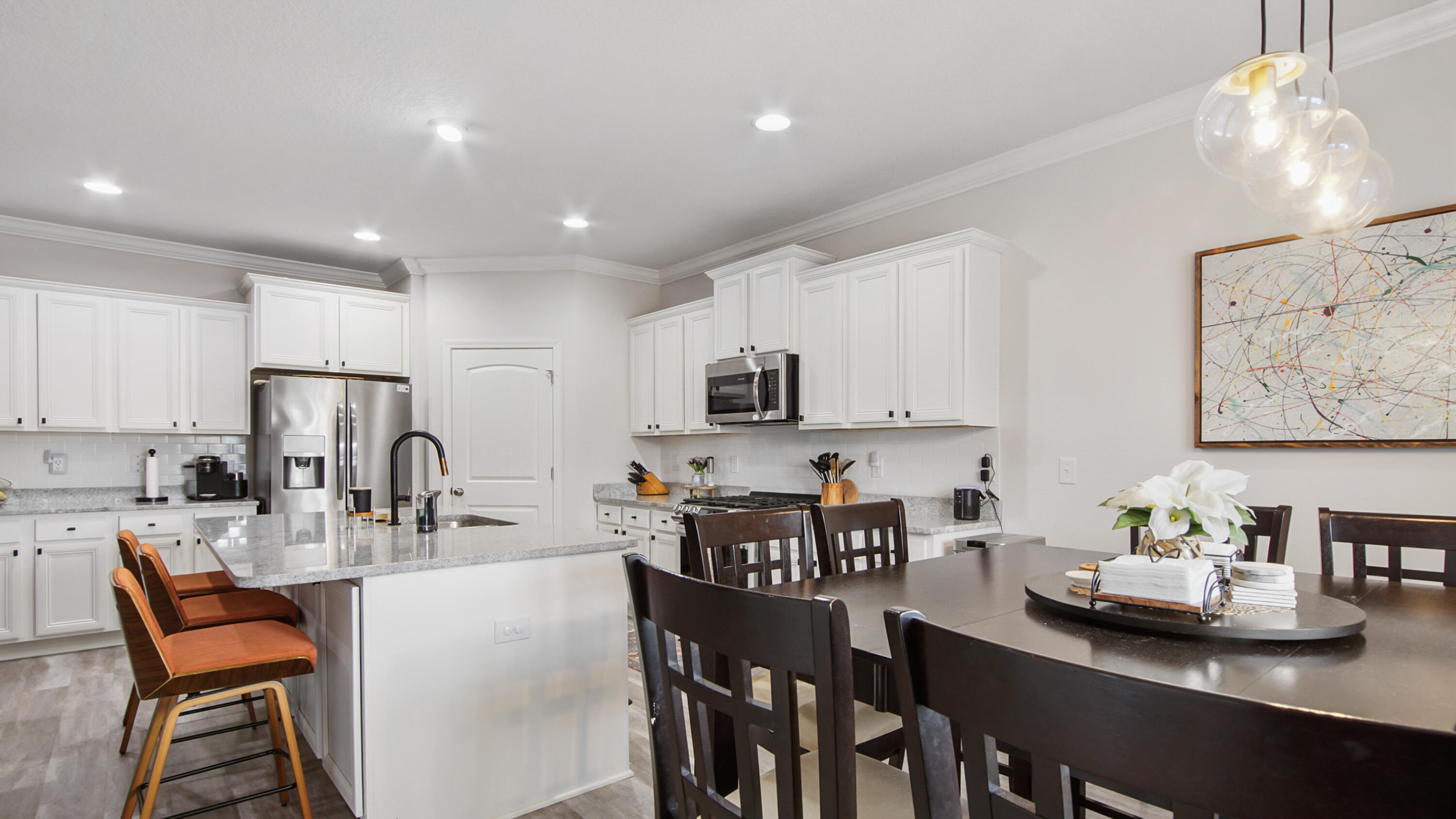 38 Norwich Road Freeport, FL 32439 - Photo 8 of 42 a kitchen with stainless steel appliances granite countertop a table chairs and a refrigerator