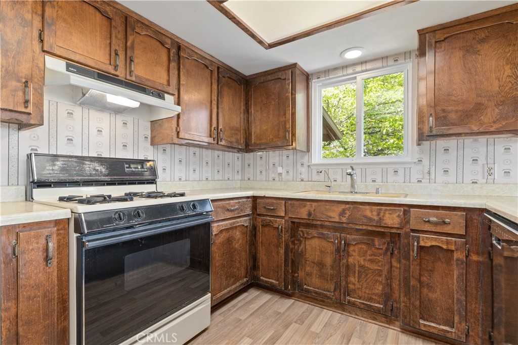 4530 San Ardo Avenue Atascadero, CA 93422 - Photo 12 of 37 a kitchen with granite countertop wooden cabinets stainless steel appliances and a large window