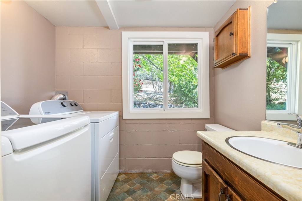 4530 San Ardo Avenue Atascadero, CA 93422 - Photo 25 of 37 a bathroom with a granite countertop toilet sink and mirror