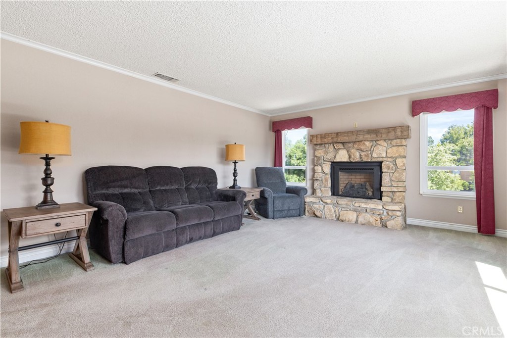 4530 San Ardo Avenue Atascadero, CA 93422 - Photo 7 of 37 a living room with furniture a fireplace and a flat screen tv