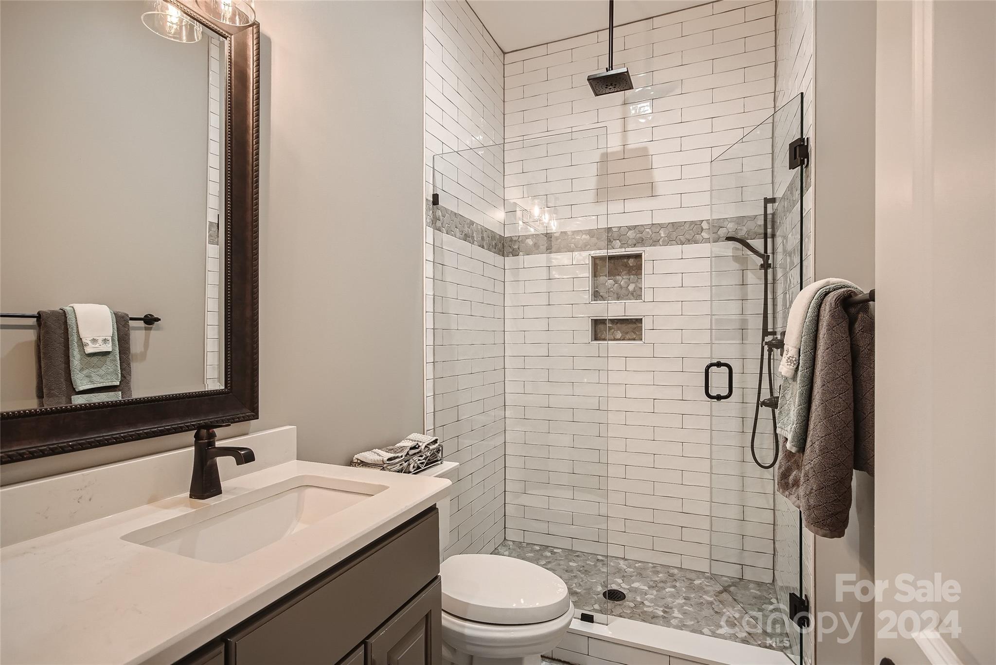 2926 Dodsworth Drive Cramerton, NC 28032 - Photo 18 of 33 a bathroom with a sink toilet and shower
