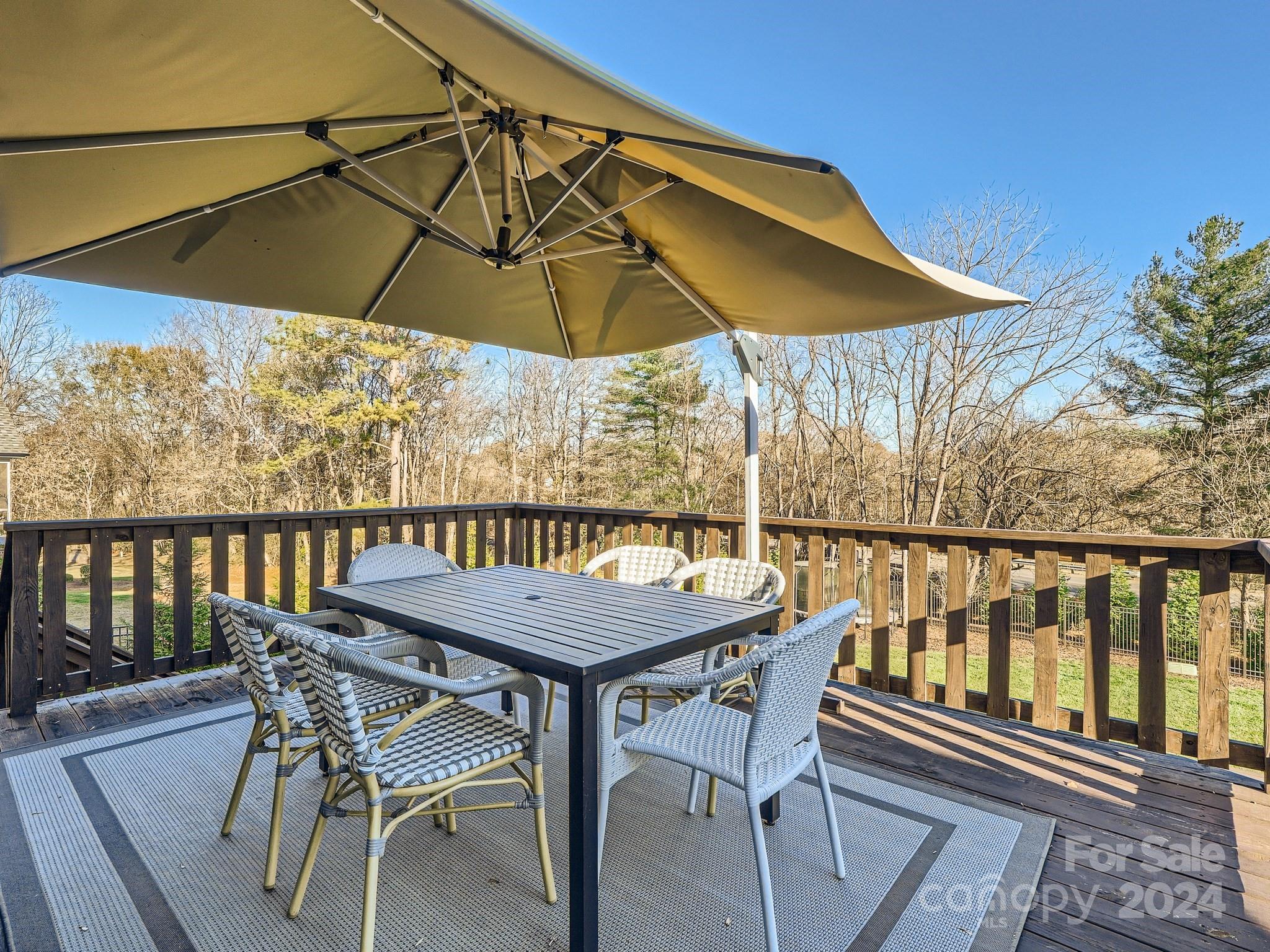 2926 Dodsworth Drive Cramerton, NC 28032 - Photo 28 of 33 a patio with wooden floor a yard a table and chairs