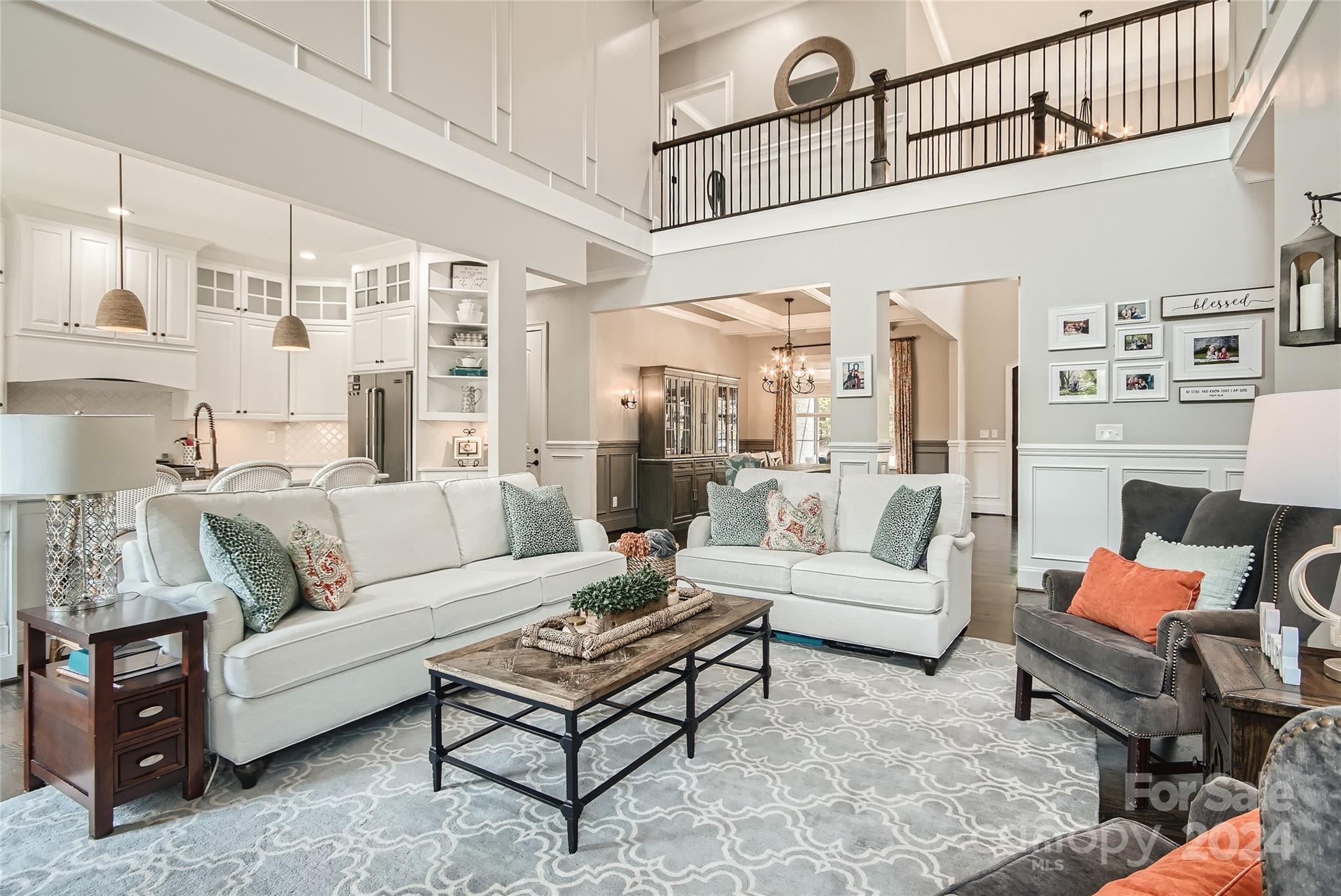 2926 Dodsworth Drive Cramerton, NC 28032 - Photo 4 of 33 a living room with furniture a rug and a chandelier