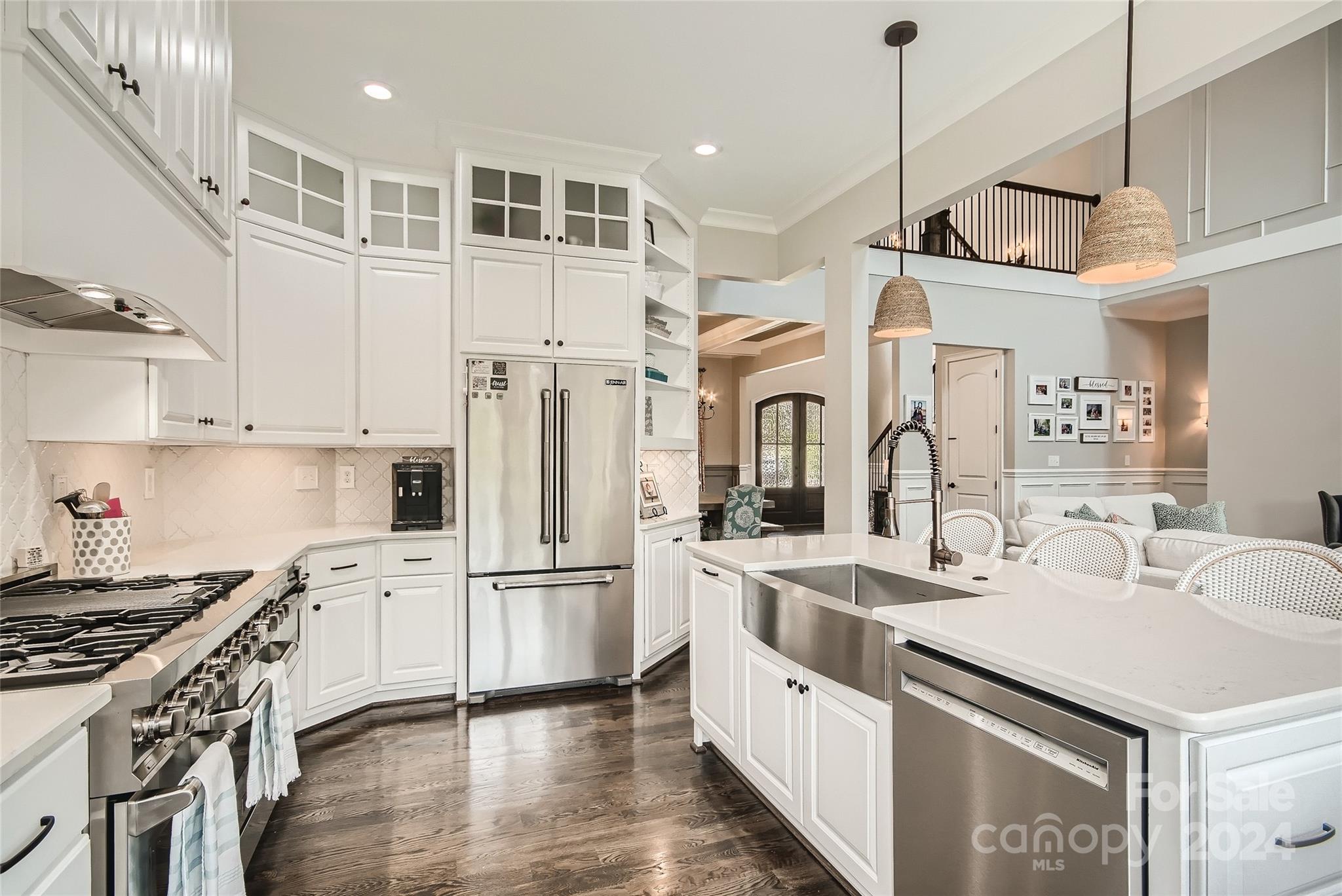 2926 Dodsworth Drive Cramerton, NC 28032 - Photo 7 of 33 a kitchen with stainless steel appliances sink stove and wooden floor