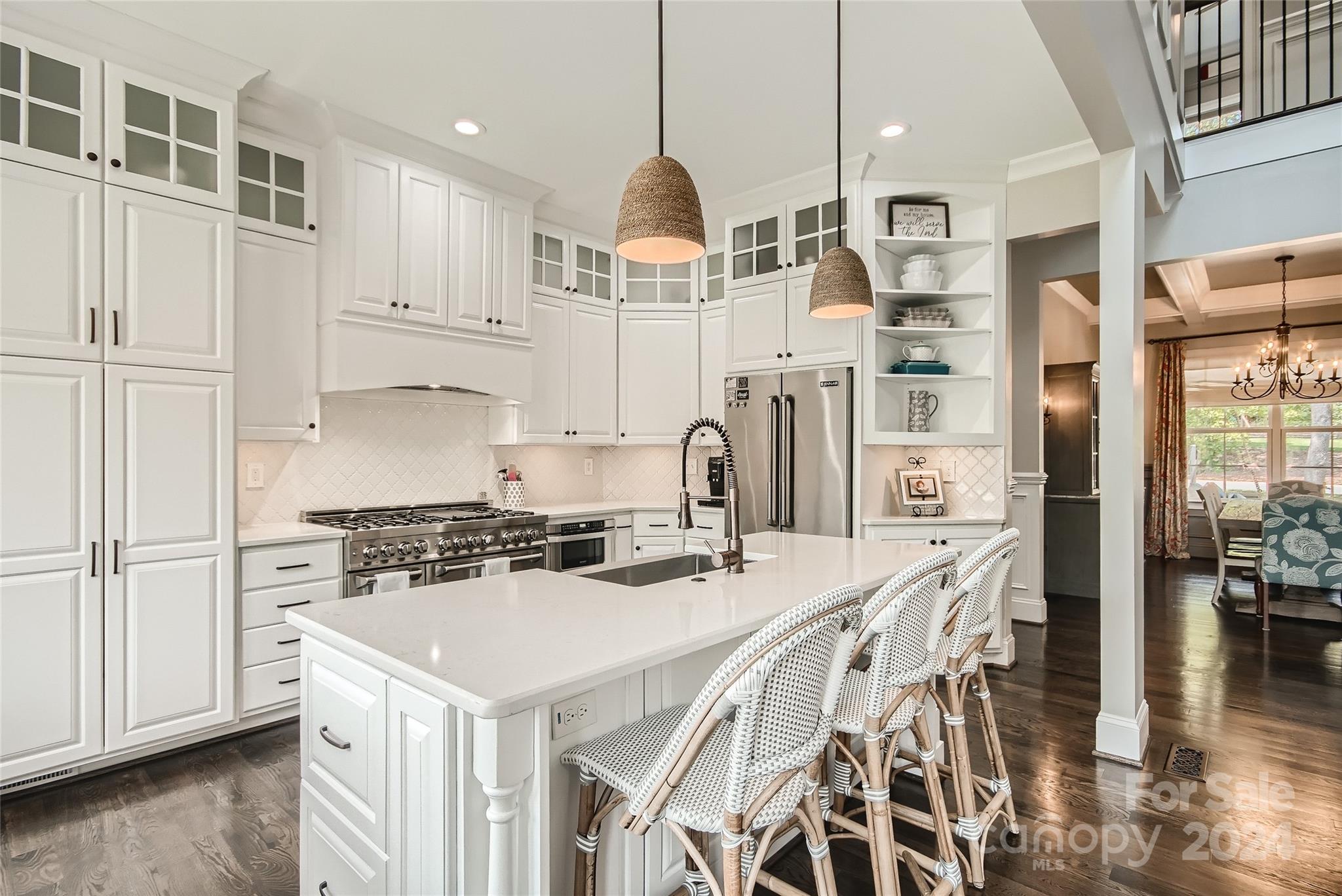 2926 Dodsworth Drive Cramerton, NC 28032 - Photo 9 of 33 a kitchen with stainless steel appliances a stove a sink island and a refrigerator