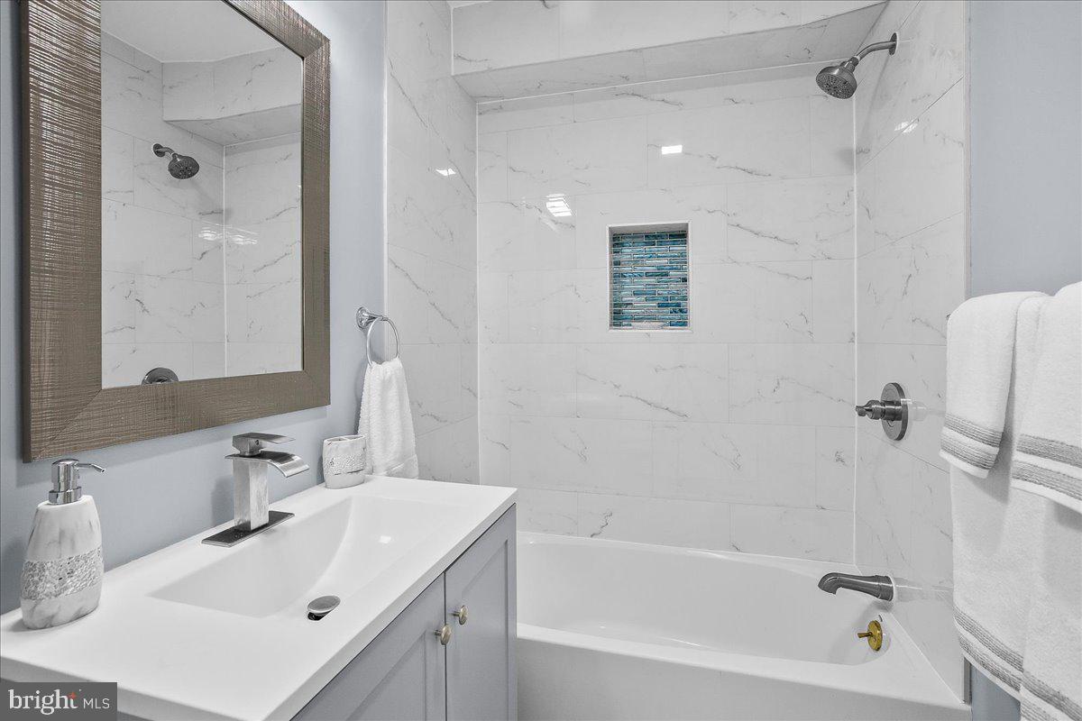 57 Transverse Avenue Middle River, MD 21220 - Photo 15 of 35 a bathroom with a tub sink and mirror