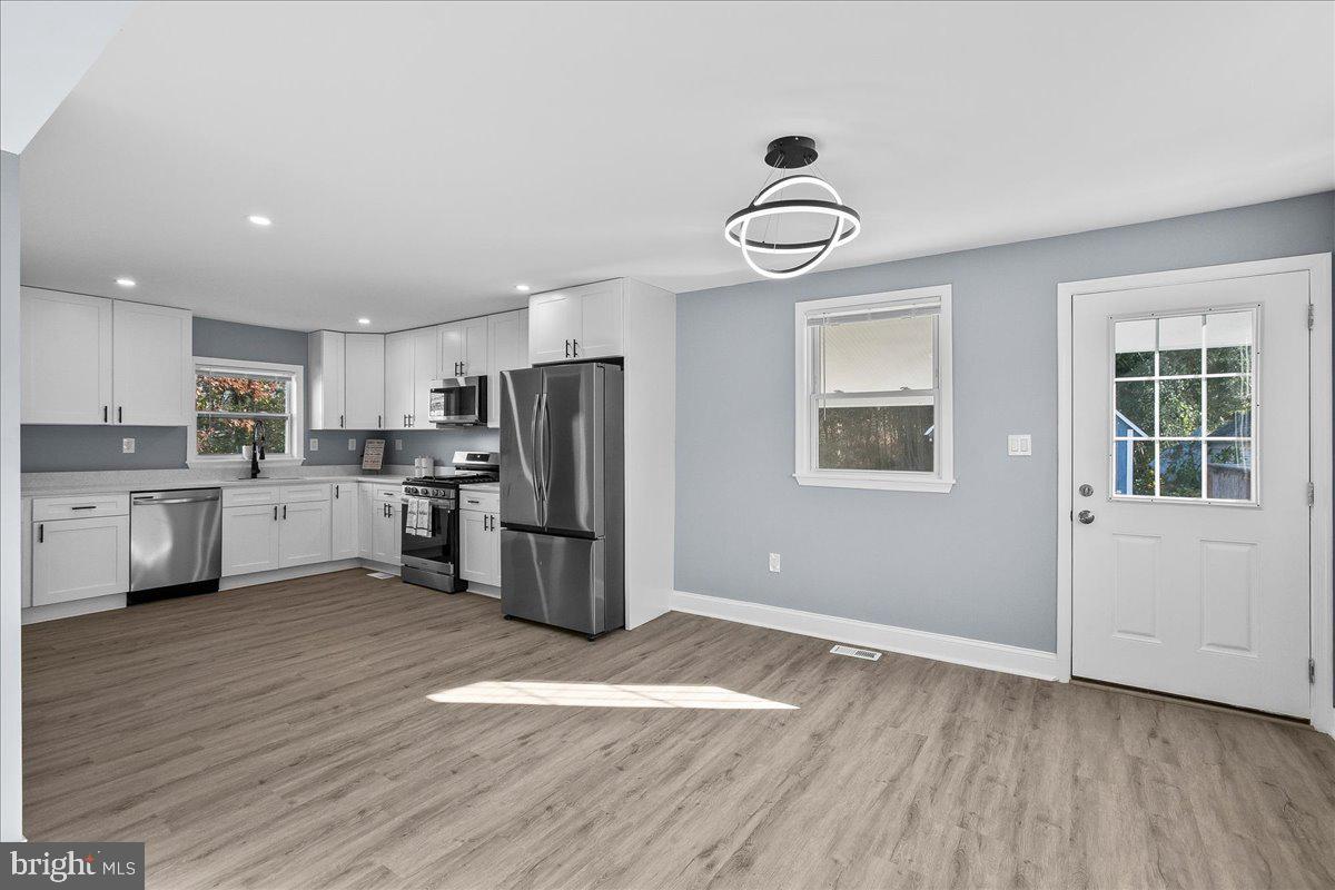 57 Transverse Avenue Middle River, MD 21220 - Photo 16 of 35 a view of kitchen with wooden floor and window