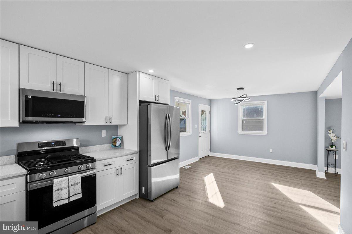 57 Transverse Avenue Middle River, MD 21220 - Photo 22 of 35 a kitchen with stainless steel appliances a stove a microwave a sink and cabinets