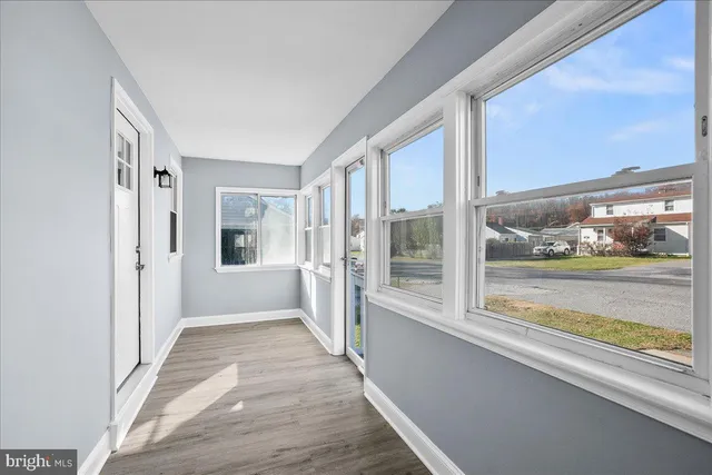 a view of an entryway with wooden floor and windows