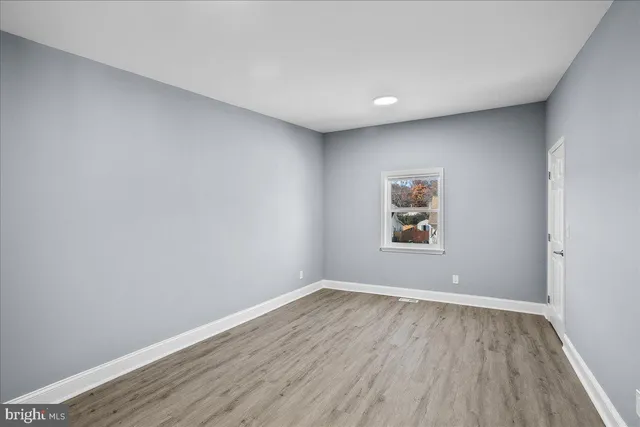 a view of room with wooden floor and window