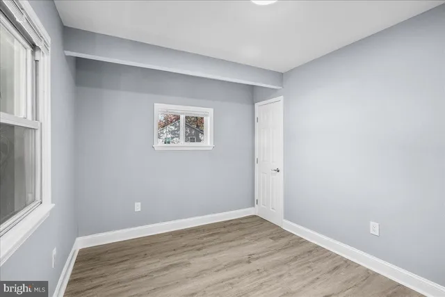 a view of room with window and wooden floor