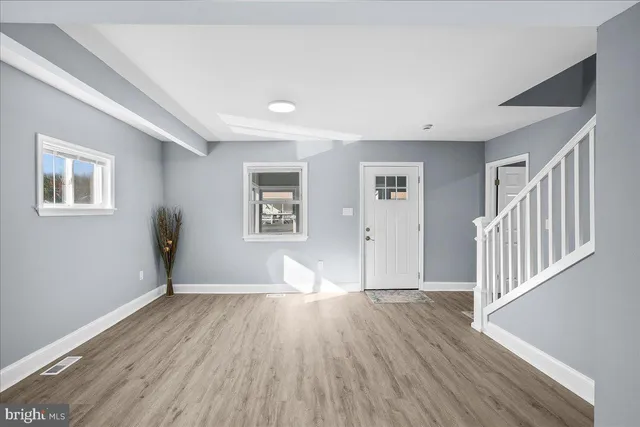 a view of empty room with wooden floor