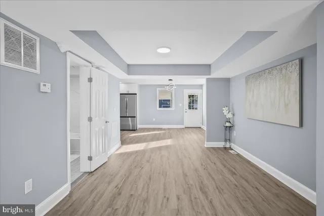 a view of a room with wooden floor and window