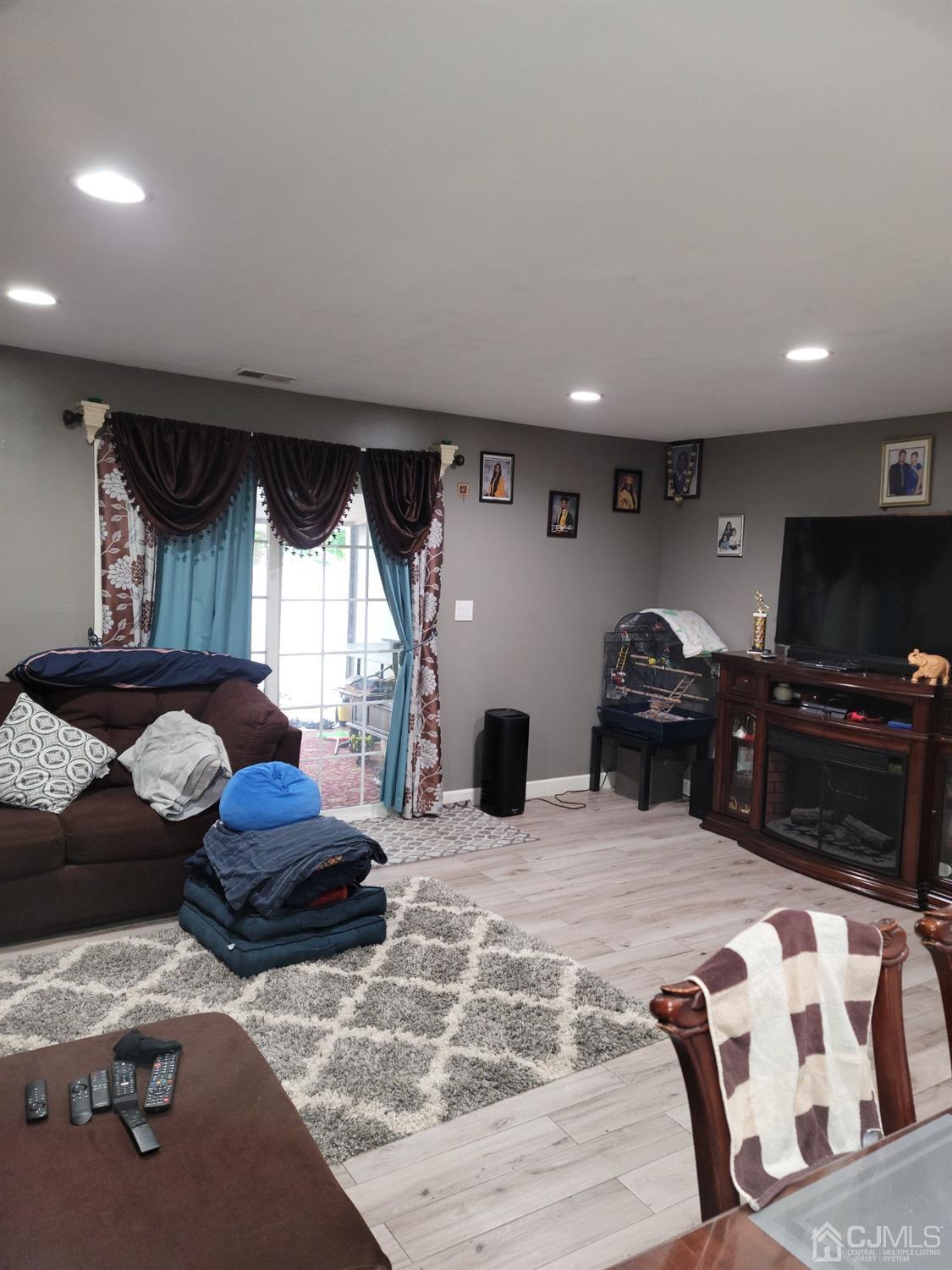 a bedroom with furniture and a flat screen tv