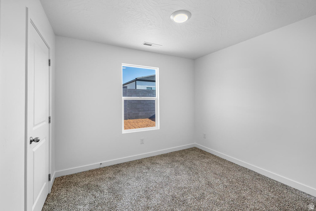 1597 South Fins Road, Unit 4177 Washington, UT 84780 - Photo 12 of 33 Neutral tone walls with an accent window, plush carpet flooring, and a flush-mount ceiling light