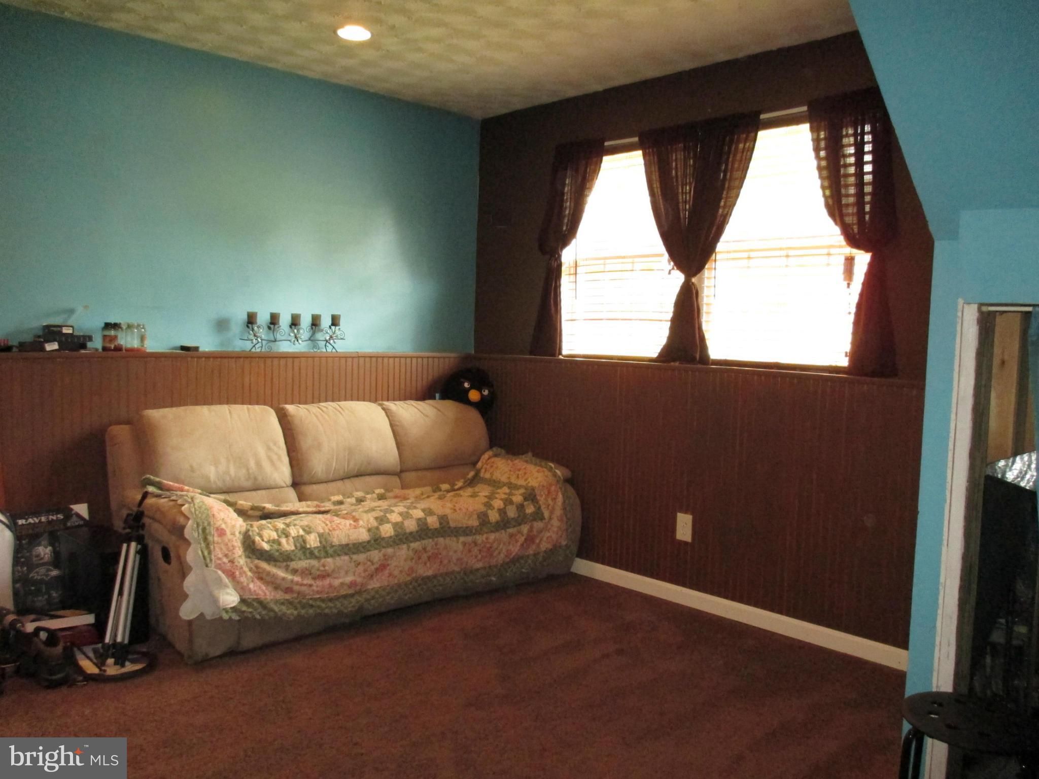 4032 Oak Road Halethorpe, MD 21227 - Photo 12 of 15 a living room with a bed and a window