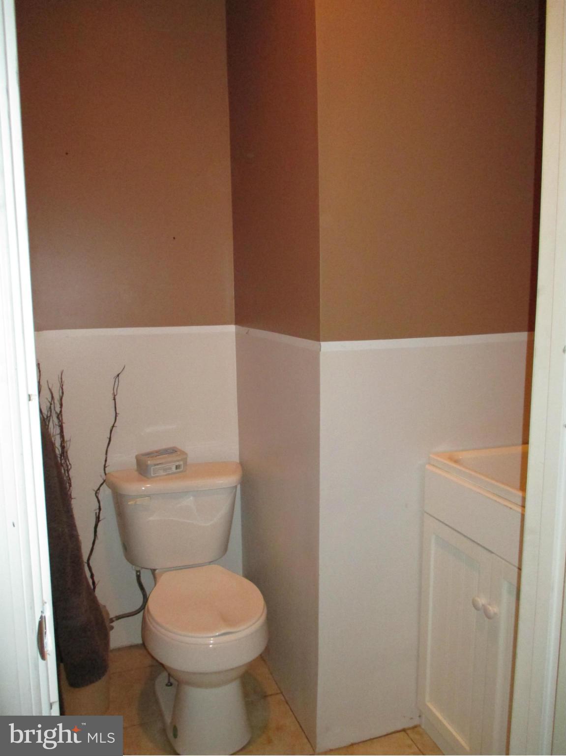 4032 Oak Road Halethorpe, MD 21227 - Photo 13 of 15 a white toilet sitting next to a shower
