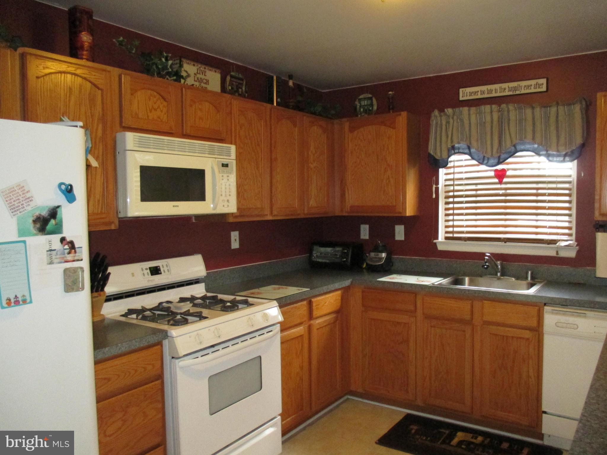 4032 Oak Road Halethorpe, MD 21227 - Photo 5 of 15 a kitchen with stainless steel appliances a stove a sink and a microwave