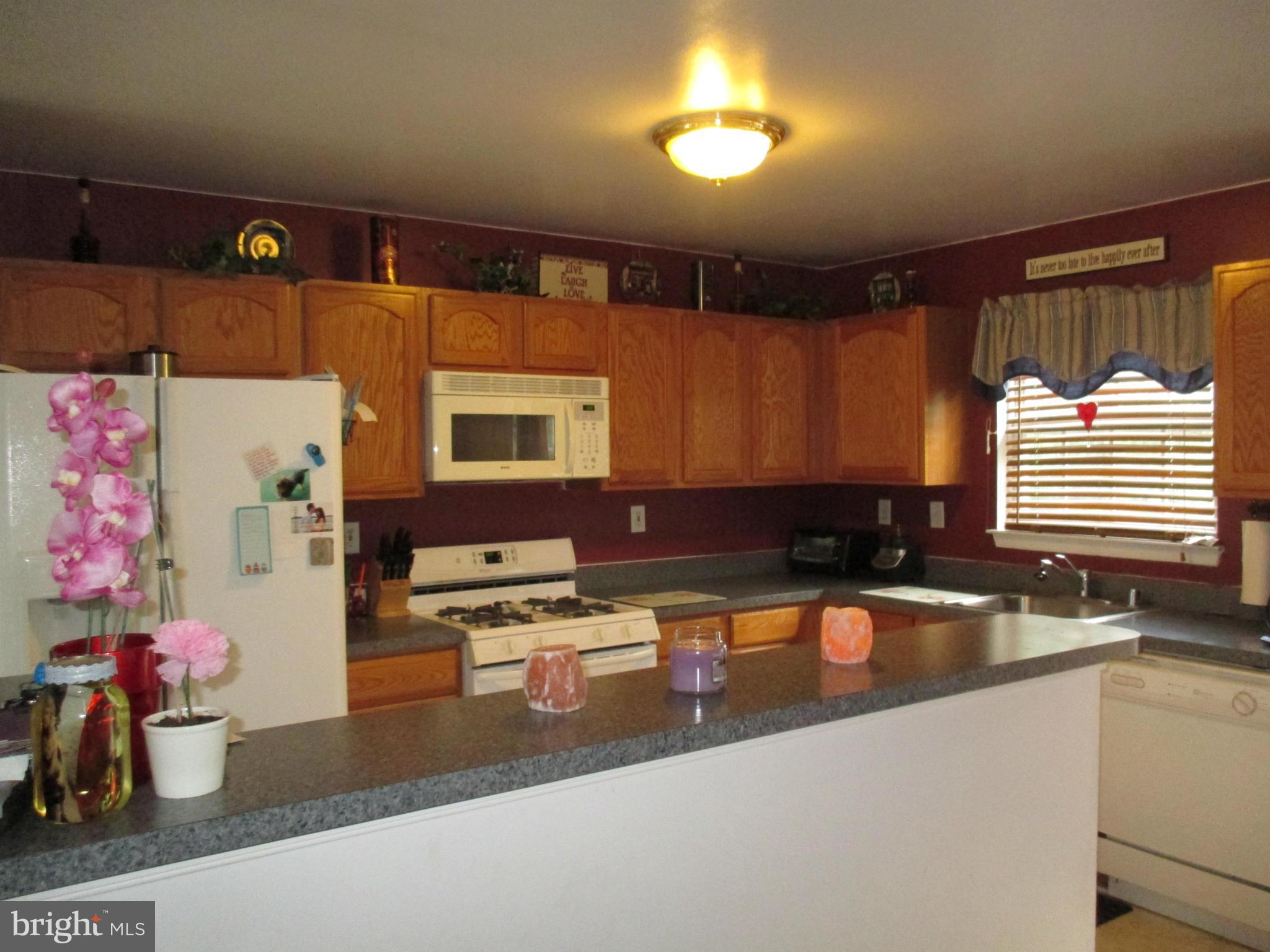 4032 Oak Road Halethorpe, MD 21227 - Photo 6 of 15 a kitchen with a sink stove and cabinets