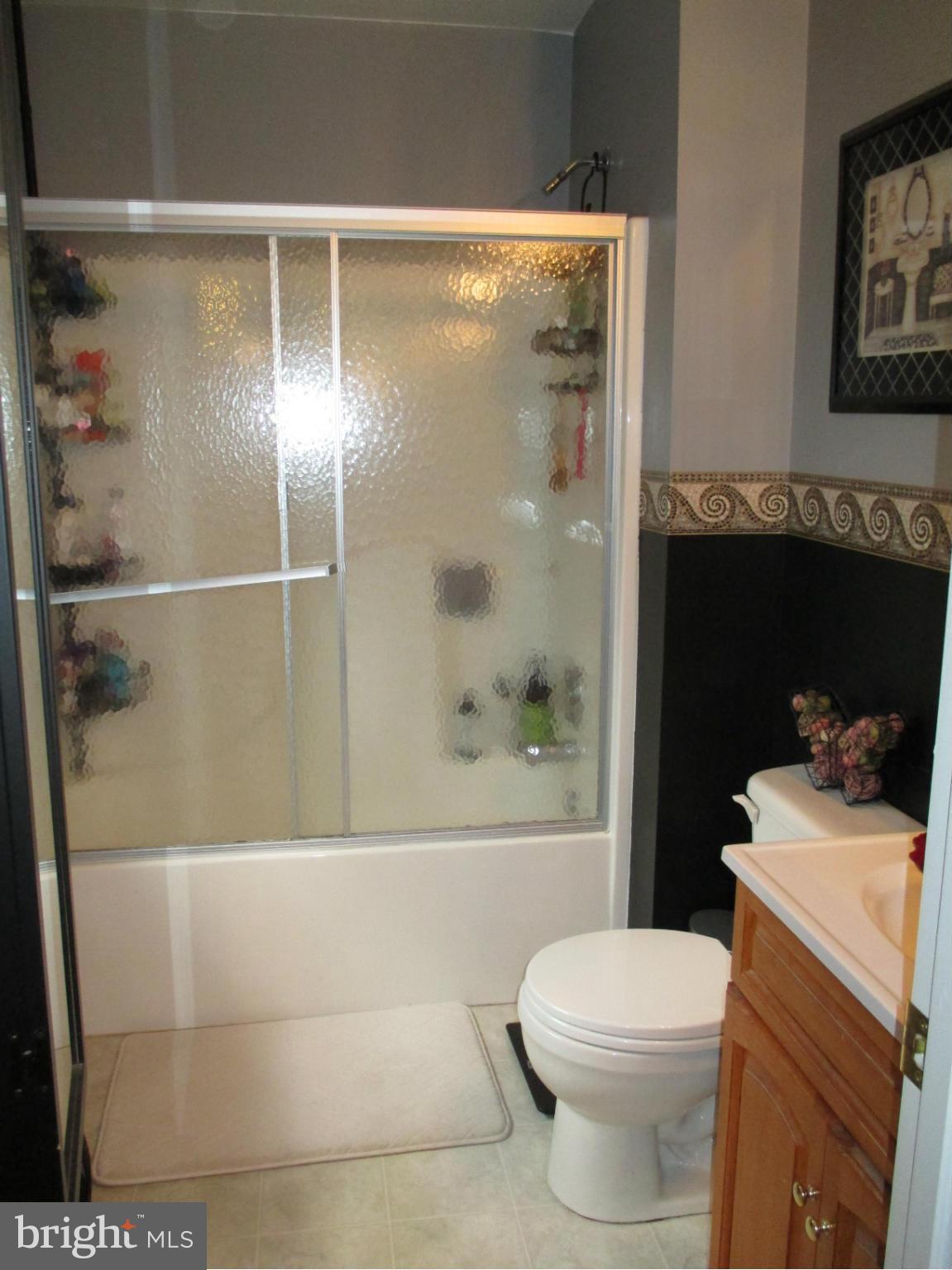 4032 Oak Road Halethorpe, MD 21227 - Photo 10 of 15 a bathroom with a shower a toilet and a sink