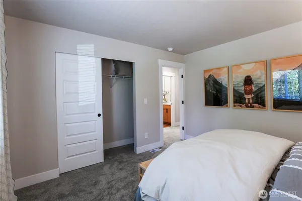 a bedroom with a large bed and a large window