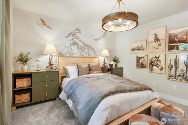 a bedroom with a bed and a chandelier