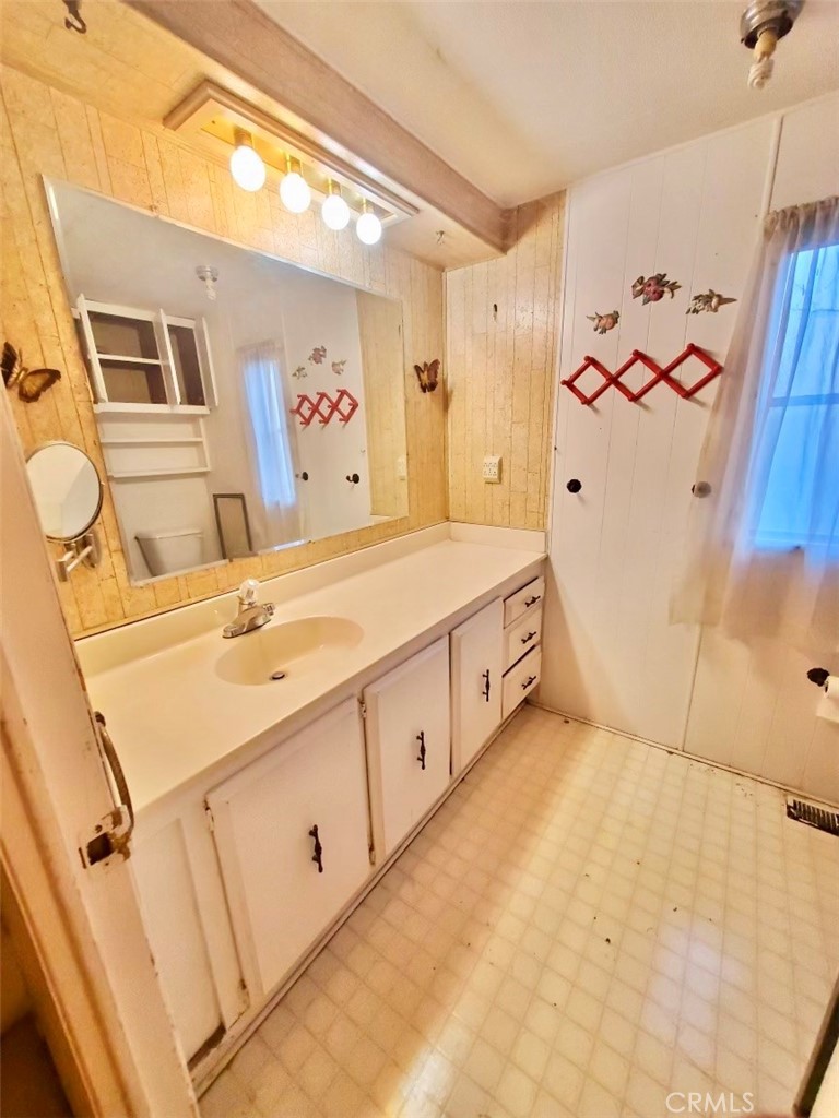 7282 Marin Street Nice, CA 95464 - Photo 24 of 69 a spacious bathroom with a double vanity sink a mirror and a shower