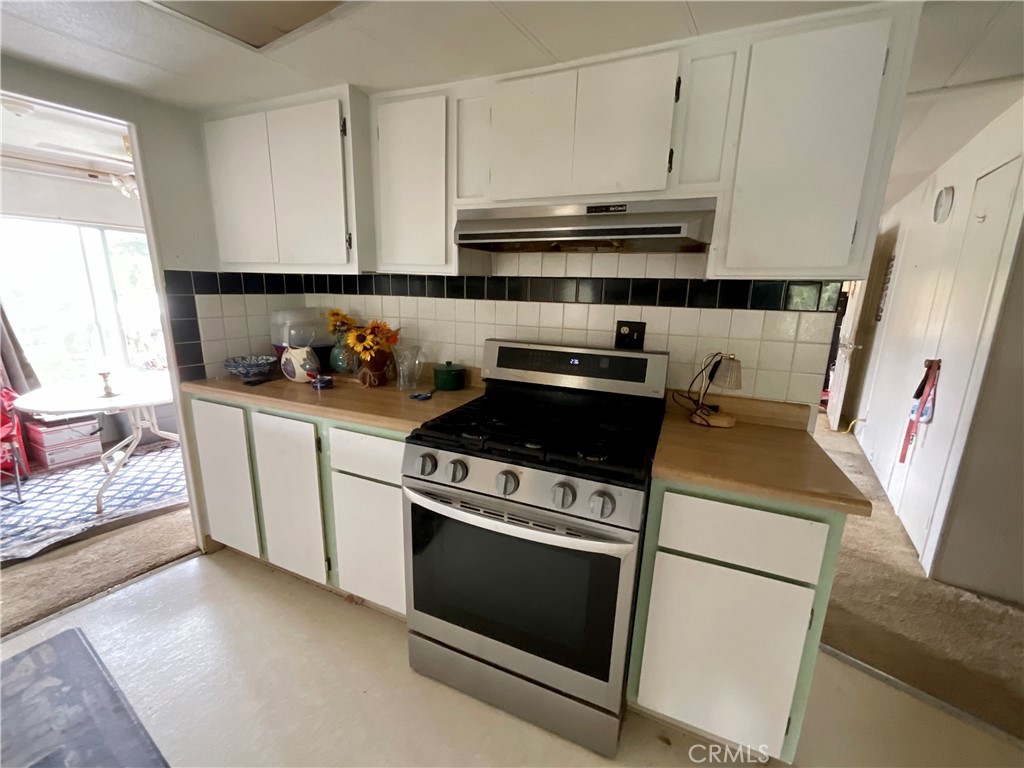 7282 Marin Street Nice, CA 95464 - Photo 6 of 69 a kitchen with a stove and a microwave