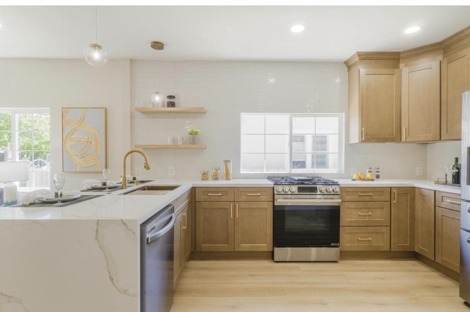 735 Locust Street San Jose, CA 95110 - Photo 13 of 21 a kitchen with a stove sink and cabinets