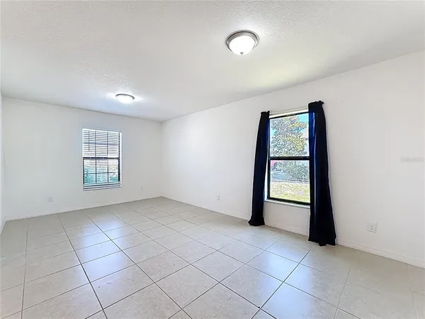 an empty room with windows and closet